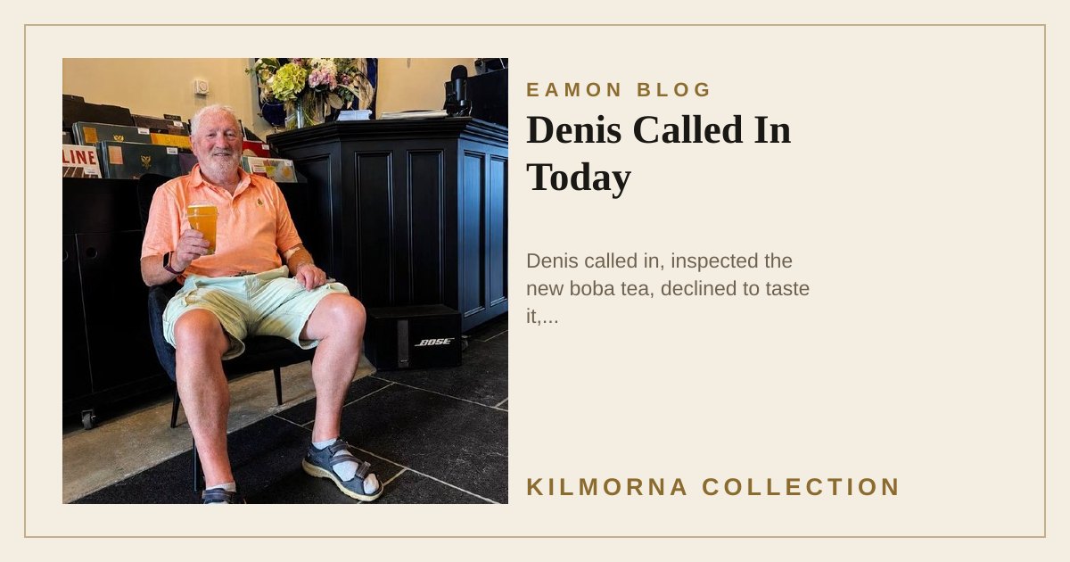 Denis seated inside The Kilmorna Collection holding a cup of iced fruit boba tea
