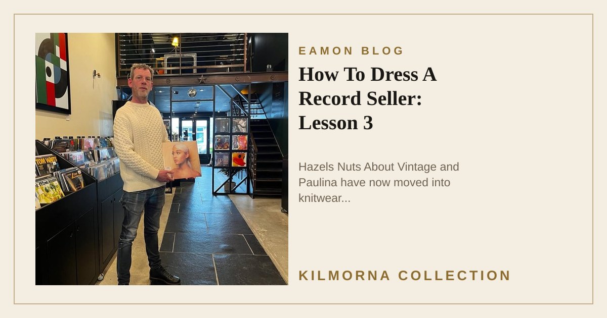 Eamon Lane wearing a cream Aran sweater and holding a record inside The Kilmorna Collection