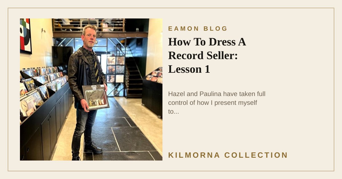 Eamon Lane wearing a leather jacket and tie while holding a Pulp record inside The Kilmorna Collection