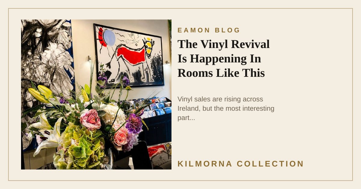 A bouquet of flowers inside The Kilmorna Collection, with vinyl records and large artworks displayed in the gallery behind it