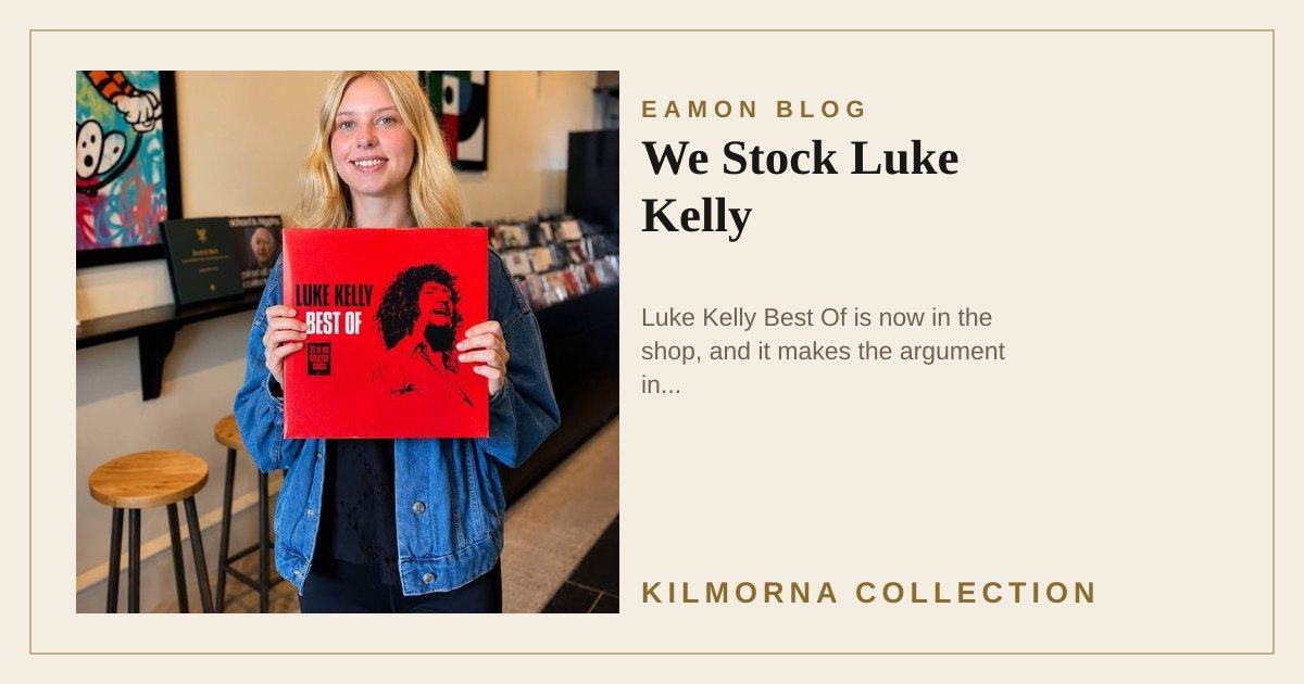 A woman inside The Kilmorna Collection holding a red Luke Kelly Best Of vinyl record